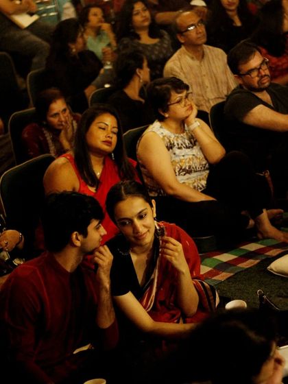 An audience engrossed in a sitar performance by Ustad Rafique Khan. The mix of seating options ensures everyone finds a comfortable spot to enjoy the classical music.