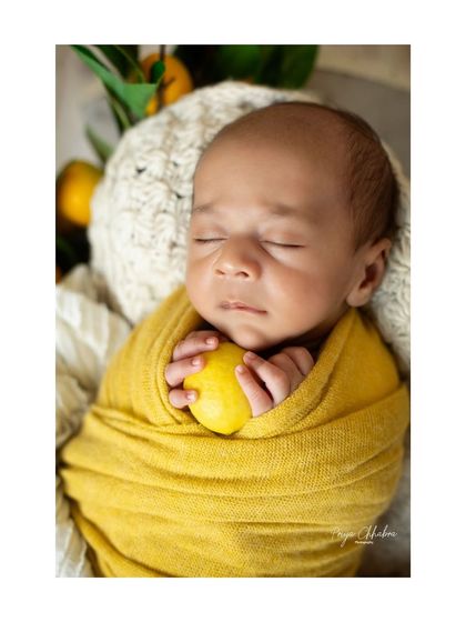 A close-up on the tiniest hands holding a lemon. It's these small details that make themed shoots so memorable and unique.