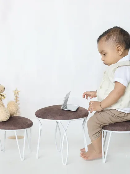 A future CEO in the making! This playful setup with a miniature laptop and teddy bear is a fun way to capture a milestone like nine months.