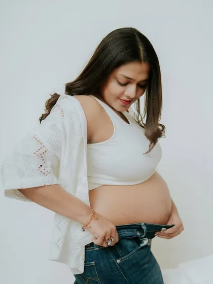 A relaxed and candid moment from a casual studio session. The simple white shirt and jeans create a timeless, effortless look.