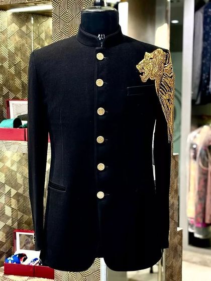 A still image of the black Jodhpuri jacket with the bold gold embroidered tiger, a powerful and unique design.