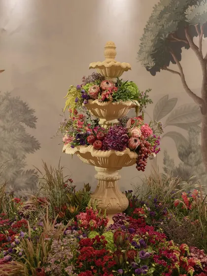 The fountain centerpiece of the 'Orchard of Life' naming ceremony, overflowing with colorful blooms.