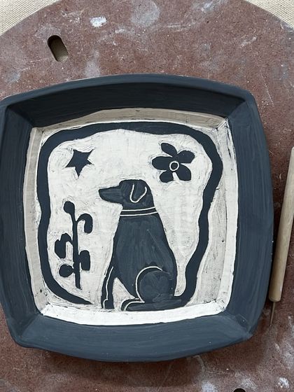 A custom plate celebrating a beloved pet, Scotch. Using the sgraffito technique, I carved the image of the dog into the clay, creating a lasting tribute. These personalized ceramic pieces make for incredibly special gifts.