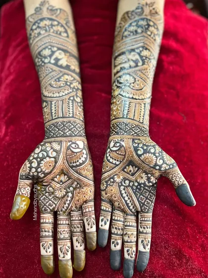 A stunning example of a full coverage bridal design for Pooja. This Indo-Arabic fusion style combines bold, dark-filled areas with delicate, fine-line work, featuring peacocks and elephants.