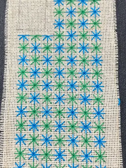 A phone insert with a star-like pattern in shades of blue and green. Each one is unique and made to order.