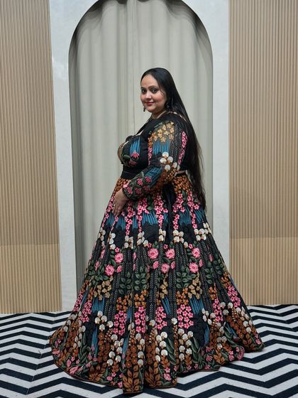 A side view of the plus-size floral lehenga, highlighting the intricate embroidery that runs all over the skirt and sleeves. It's all in the details.