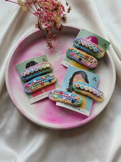 Another look at our popular name clips, beautifully arranged on a platter. Each one, from 'Falguni' to 'Anchita', is a unique piece handmade with love.