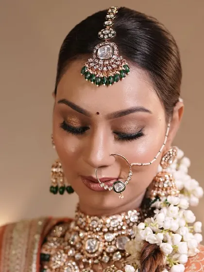 She’s a queen, and her soul is pure royalty. This close-up shot highlights the golden eyeshadow and the intricate details of her nath and floral braid.
