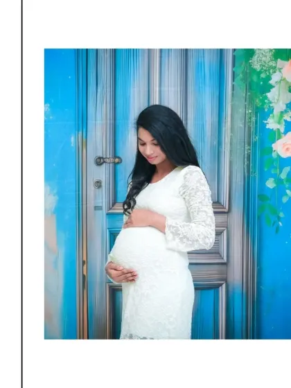 A beautiful and simple solo portrait. The mom-to-be is wearing a lovely white lace dress, and the vibrant blue door backdrop adds a wonderful pop of color, creating a fresh and modern feel.