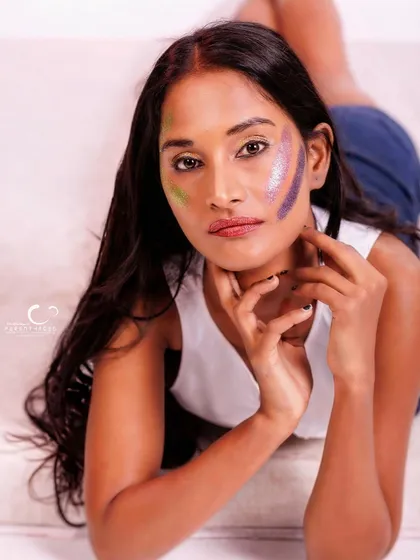 An intimate and engaging portrait. The composition is close and personal, and the glitter makeup adds a unique artistic touch.