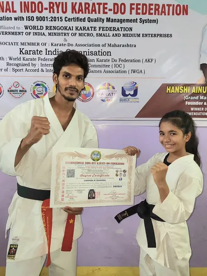 Posing with my student Lekissha and her black belt certificate. As a coach, seeing my students achieve their goals is the greatest satisfaction.