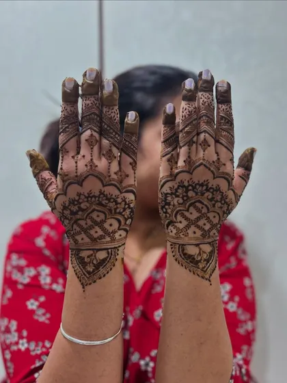The back of the hands from the Teej special mehendi. The design features a beautiful mandala style pattern with detailed work on the fingers.
