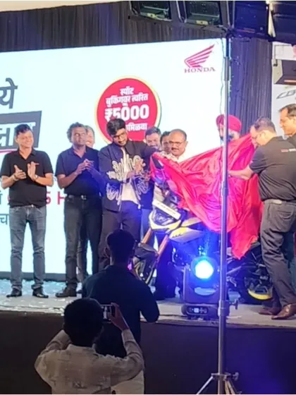 The grand reveal of the new Honda motorcycle, immediately following my sand art performance which set the stage for the launch.