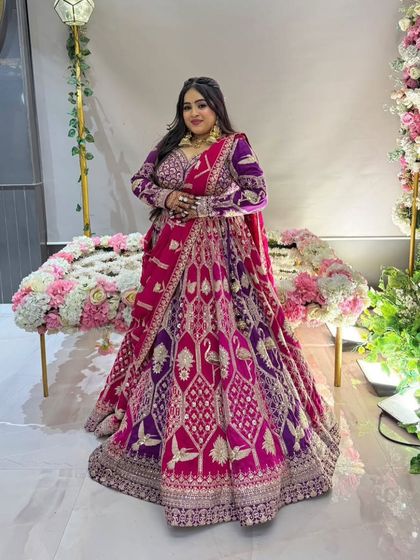 For brides who love color, this multi-toned lehenga in shades of pink and purple is a showstopper. The velvet fabric and detailed weaving make it a luxurious choice for a winter wedding.