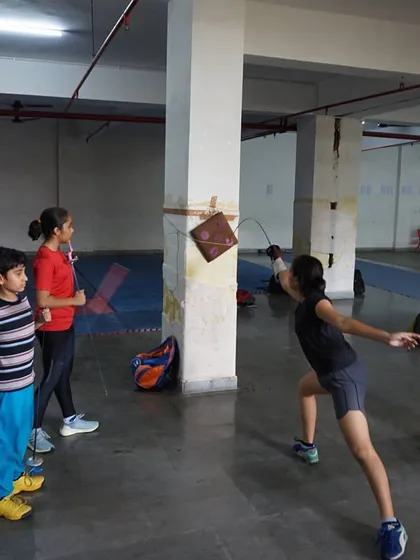 A student practices her lunge and aim by hitting a target. Target practice is an excellent way to improve accuracy and the precision of the blade tip.