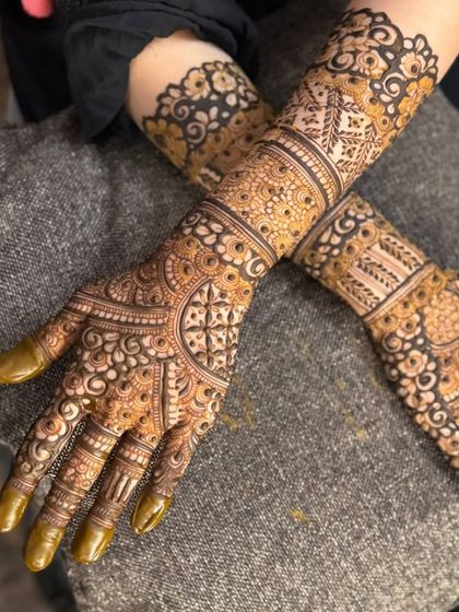 A detailed close-up of the palms, focusing on the finger work and central motifs.