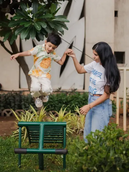 Capturing kids in action is my specialty. This shot of a little boy jumping with his mom's help shows the energy and trust that makes these candid family photos so dynamic and full of life.