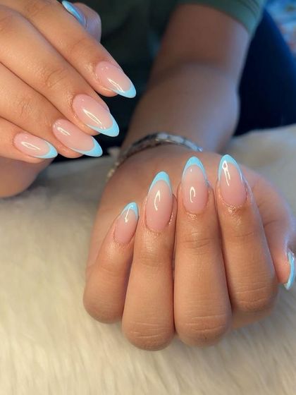 A full set view of the elegant baby blue French manicure on long almond nails.