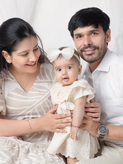 A candid moment of smiles and interaction during a studio family session.