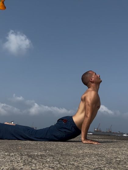 Urdhva Mukha Svanasana, or Upward-Facing Dog, is a powerful heart-opener. Practicing it by the sea, with the vast sky above, enhances the feeling of expansion and freedom in the body and mind.