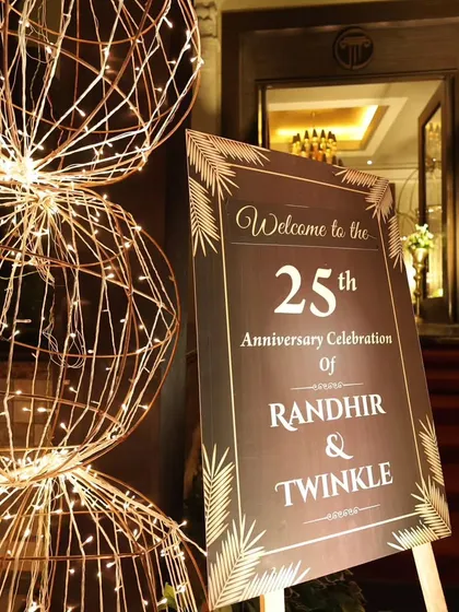 A welcome board is essential for personalizing an event. For this 25th anniversary, I designed a simple yet elegant sign that complemented the warm lighting of the entrance arch, officially welcoming guests to the celebration.