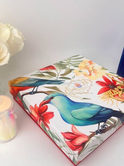 Our alternate Diwali gift box design, showcasing a vibrant bird and floral pattern. We believe the gifting experience starts with beautiful presentation, and our boxes are a gift in themselves.
