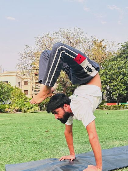 A powerful scorpion handstand pose, demonstrating advanced strength, balance, and flexibility. Asanas are a key part of the yoga journey.