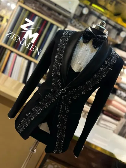 A side-angle shot of the black and silver leaf tuxedo, showcasing the design's flow and the suit's sharp tailoring.