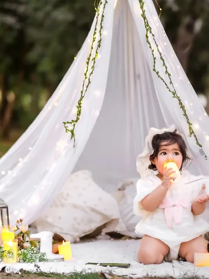 Curious about the warm glow of the candle. I ensure all props are safe for babies while creating a beautiful, storybook atmosphere.