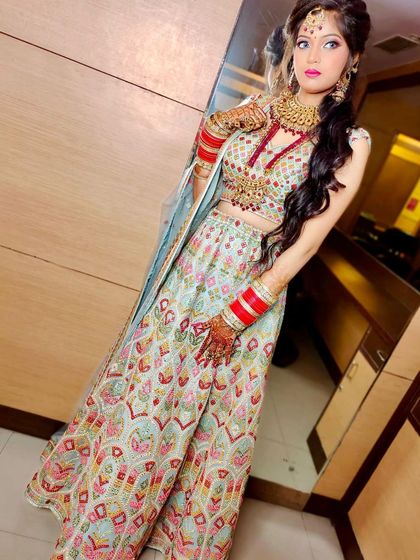 Another angle of the multi-colored embroidered light blue lehenga. The heavy gold and red jewellery set provides a beautiful contrast to the pastel outfit.