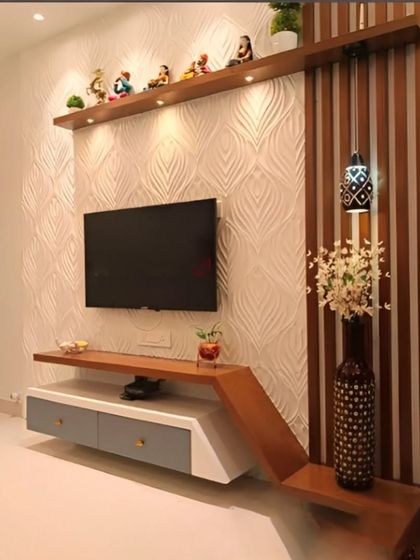 This TV unit features an asymmetric design for a unique, modern look. We combined a textured white back panel with wood-finish floating shelves and a dual-tone console, creating a dynamic and stylish focal point in the room.