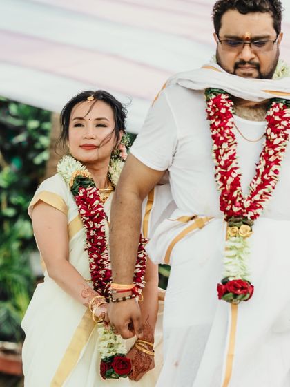A classic portrait of the couple during their South Indian beach wedding, adorned with beautiful garlands. The simplicity of the shot highlights their serene connection.