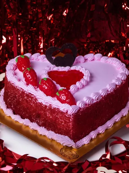 A heart-shaped strawberry cake, perfect for Valentine's Day. The fresh strawberry flavor and romantic design make it a sweet gesture of love.