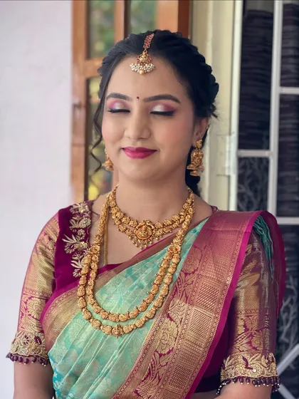 A close-up of Harshitha's makeup, showing the soft pink eyeshadow and matching lip color.