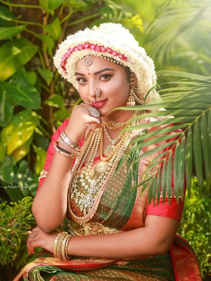 A series of images capturing the joy and beauty of a model in a traditional South Indian bridal look, complete with an elaborate floral headpiece. The focus is on her expressive smile and the rich textures of her attire.