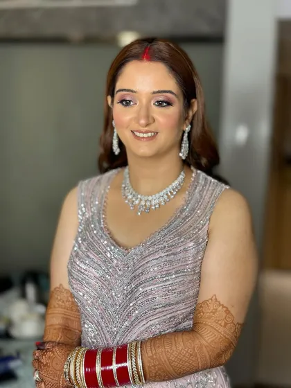 The soft waves and delicate tiara complete this fairytale reception look. The makeup is kept fresh and luminous.