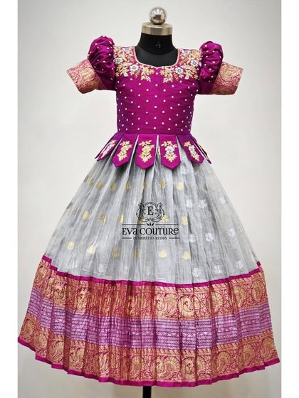 A unique combination of a grey Kanchi cotton skirt and a magenta blouse with a petal-style peplum and floral embroidery.