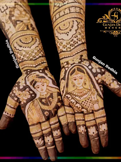 A full bridal design featuring portraits of the bride and groom. The intricate details on their clothing and the surrounding patterns make this a work of art.