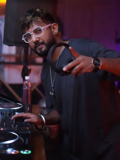 A duplicate of me holding my headphones, ready to mix.