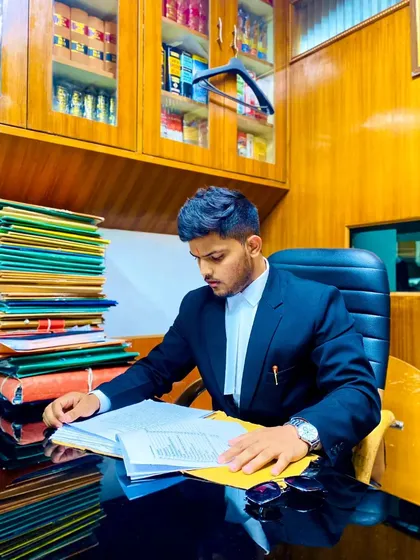 Success in the courtroom is built on hours of preparation. Here I am in my office, deep in case files, building the arguments that will defend my client's freedom.