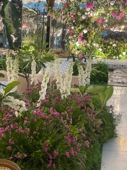 We love a challenge, and transforming an ancestral indoor hall into this magical, overgrown garden was a dream. With a mirrored ceiling reflecting thousands of blooms and chandeliers, we created an immersive environment to kick off the wedding festivities.