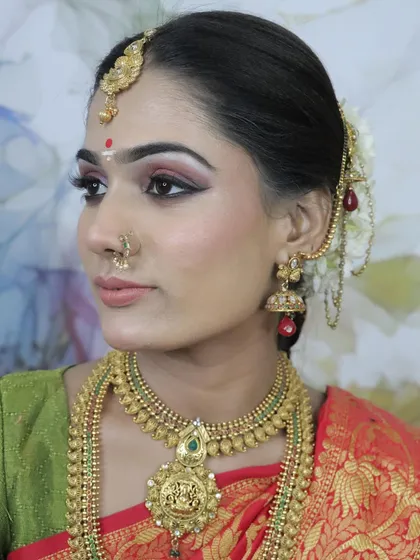 A student's work showcasing a South Indian bridal look. The sharp winged eyeliner, red bindi, and traditional gold jewellery are key features of this classic style.