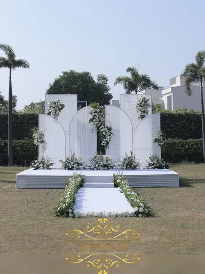 A wider view of the outdoor stage, showing its placement on the lush green lawn of the Jaypee resort.