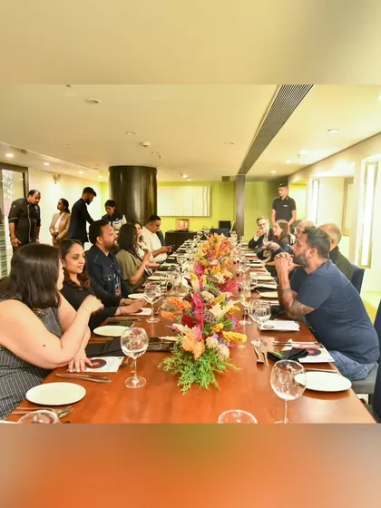 A view of the beautifully set long table for our Chef's Table Series. The floral arrangement and intimate setting create a perfect atmosphere for a unique dining experience.