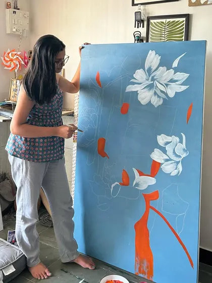 My sister helping out in the studio, adding color to a large canvas. My studio is a space for shared creativity and family.