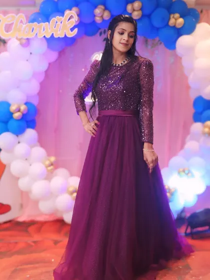 A beautiful portrait of the birthday girl. This purple sequined gown is a glamorous and elegant choice for any birthday party.