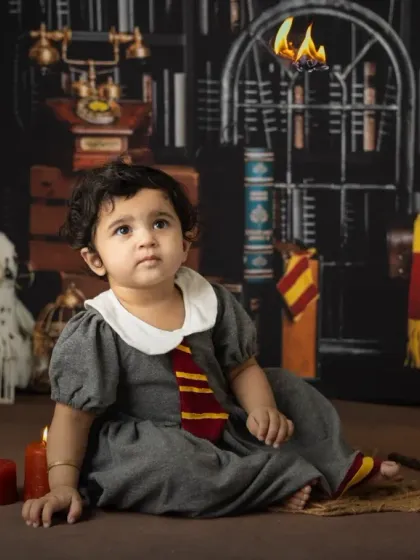 It's not just for Harry. This little girl makes a perfect Hermione Granger, captured in our Hogwarts library set for her first birthday.