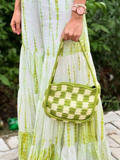 Not your regular bag, honey. This handmade crochet checkerboard bag is bold and born to stand out.
