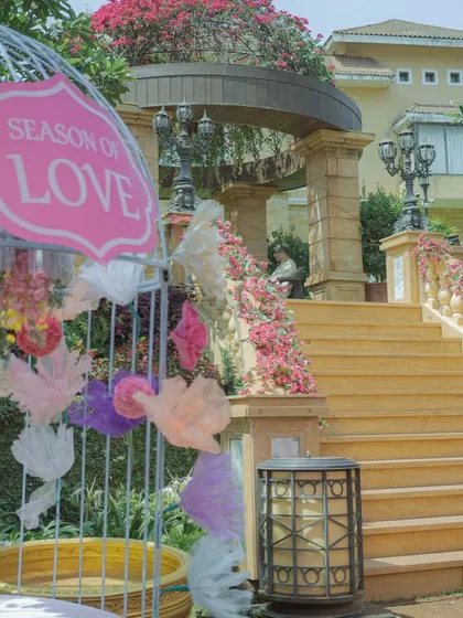 A whimsical detail from the pastel Haldi decor, with a birdcage sign that says 'Season of Love'.