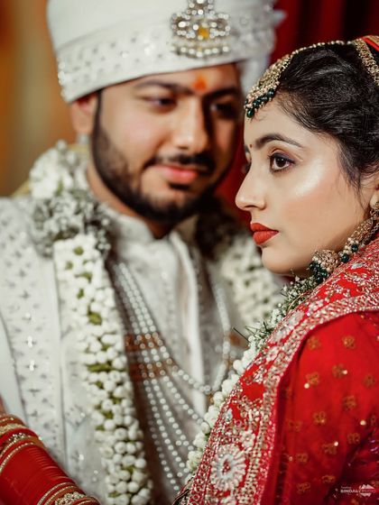 A close-up, intimate portrait of the couple during their wedding ceremony. The groom's loving gaze towards his bride speaks volumes, a candid moment of pure affection.